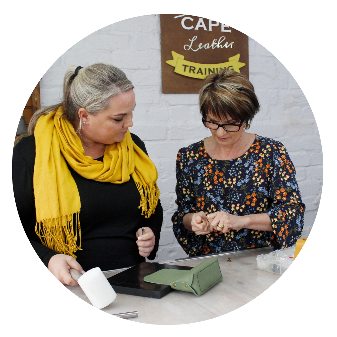 Two women engaging in hands-on leather craft training session at Cape Leather Training