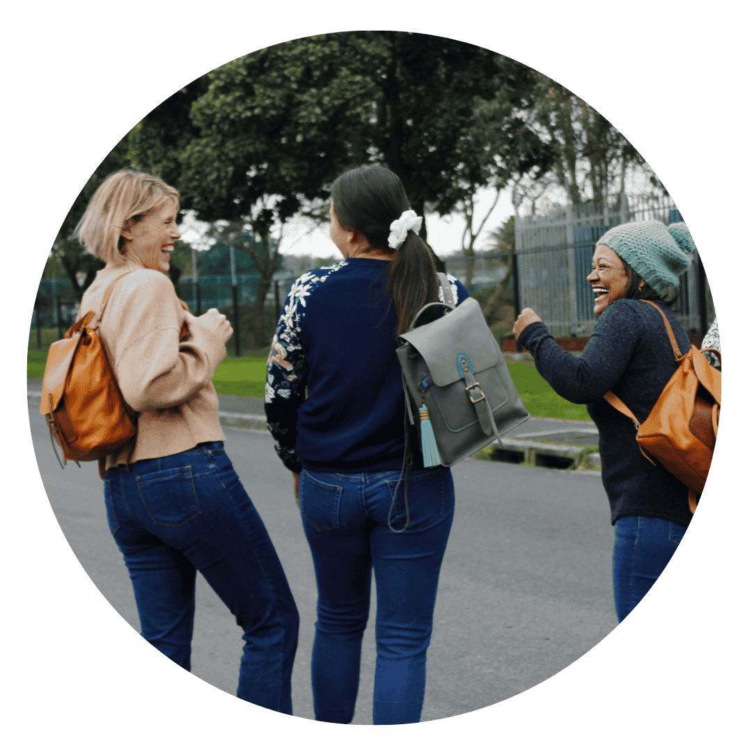 Three women wearing handcrafted leather craft backpacks, walking outdoors and enjoying their time after a creative workshop in Cape Town.
